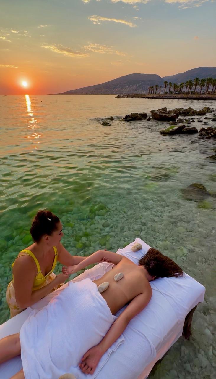 Sunset massage on the shoreline with hot stones