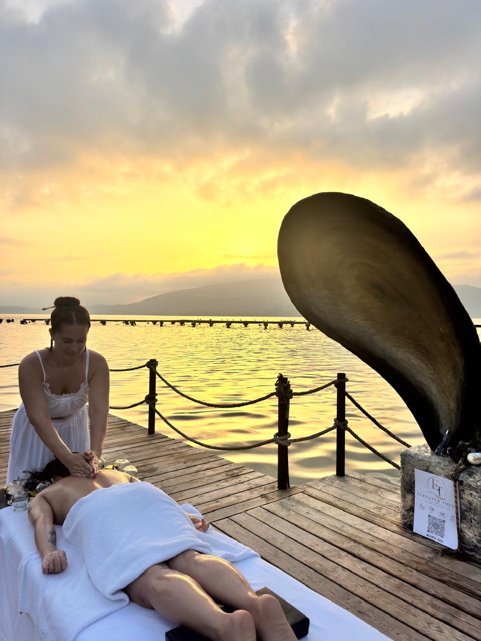 Massage on a wooden pier at golden hour